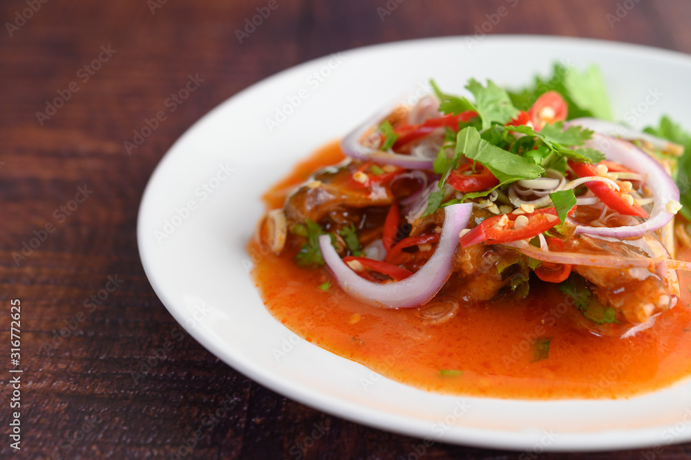 Spicy salad of sardine with tomato sauce in white dish Spicy salad of sardine with tomato sauce in white dish