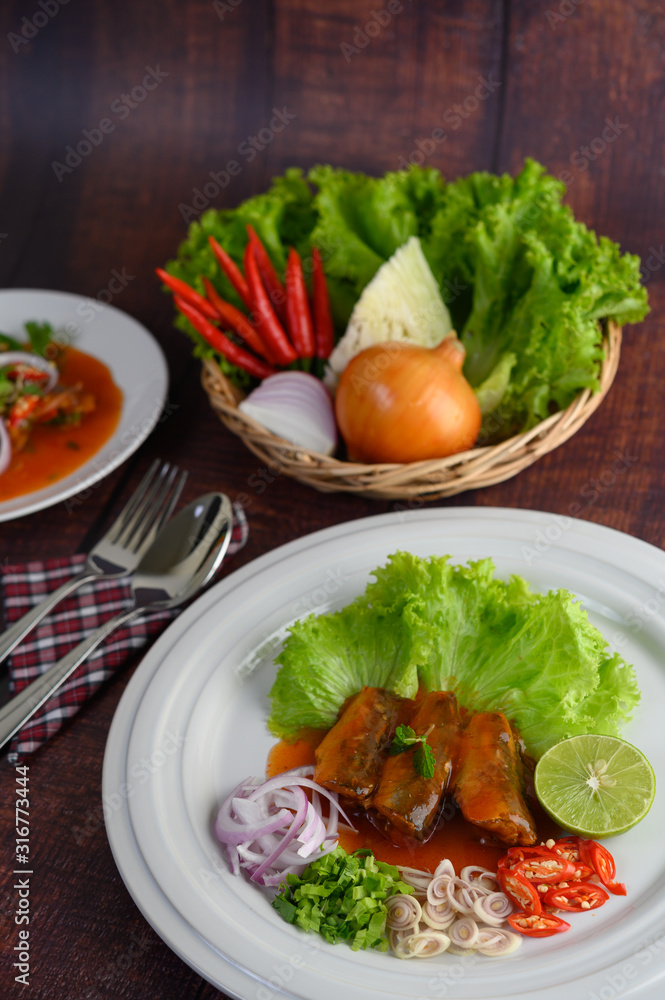 Spicy salad of sardine with tomato sauce in white dish Spicy salad of sardine with tomato sauce in white dish