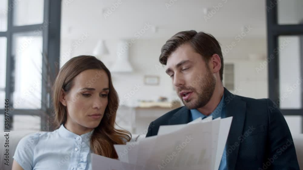 Young couple discussing family business in home office in slow motion.