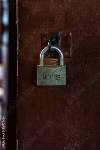 Metal rustic door lock with "HOUSE" wording.