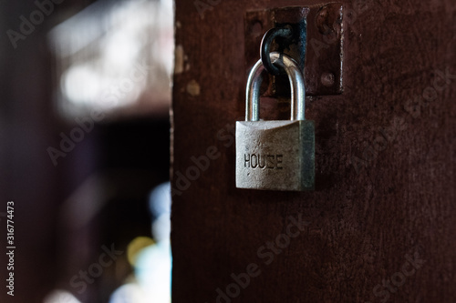 Metal rustic door lock with "HOUSE" wording.
