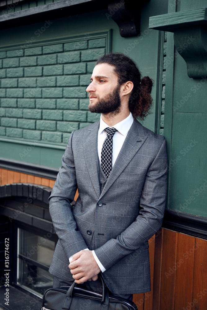 Attractive bearded young man in classic suit with bag. Elegancy Attractive bearded young man in classic suit with bag. Elegancy