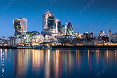 London skyscraper skyline with reflection in Thames river during twilight in London  UK