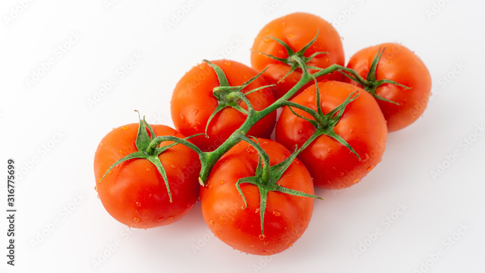 Grape of red tomatoes on a white background. Isolated