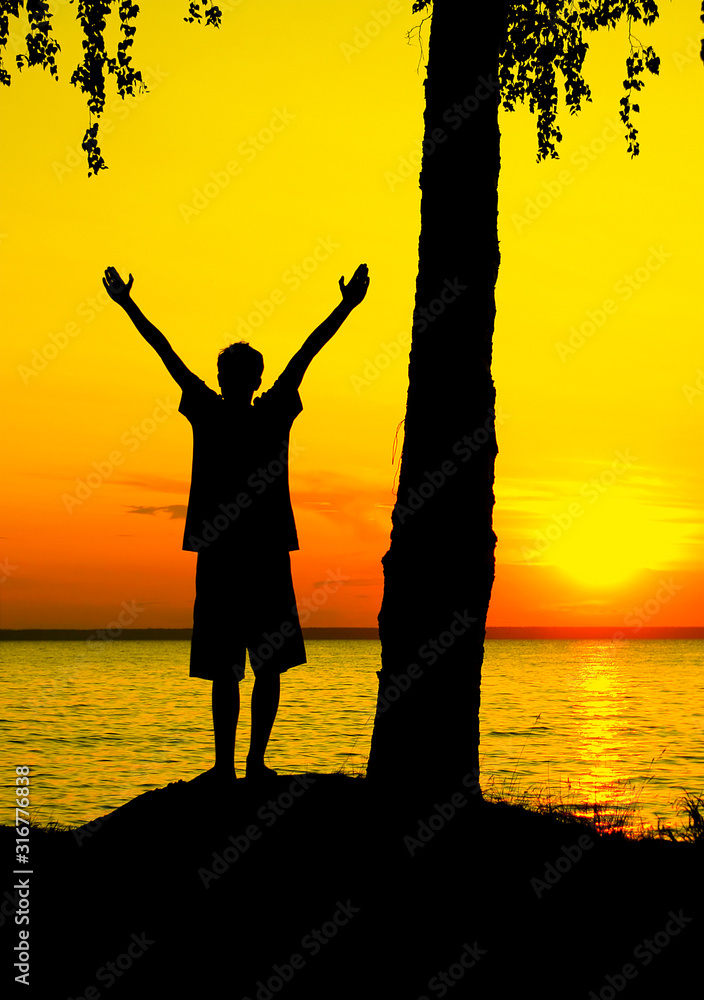 Fototapeta premium Silhouette of a Boy at Sunset