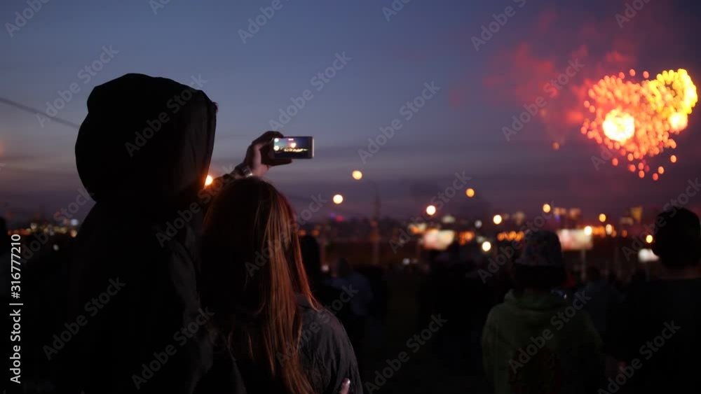 Young couple admires night fireworks in the city Young couple admires night fireworks in the city