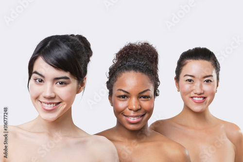 Beauty portrait of three young multi-ethnic women over white background