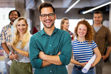 Happy business people celebrating success at company