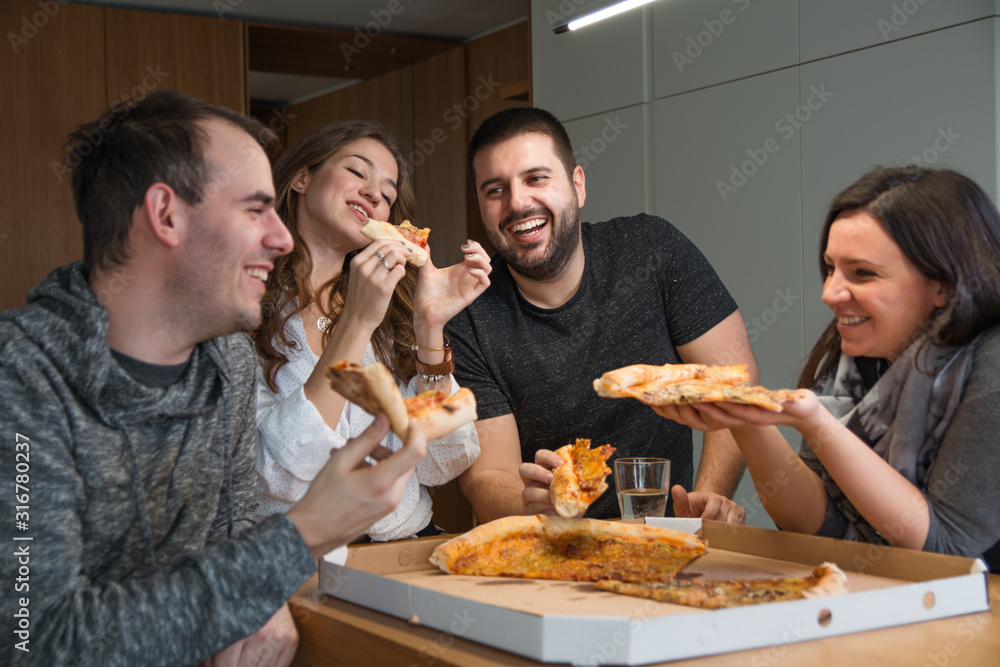 Friends having fun while eating pizza at home - obrazy, fototapety, plakaty 