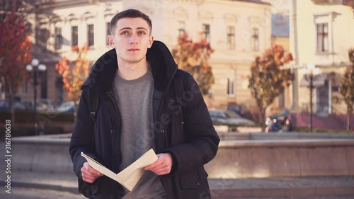 Handsome guy lost in foreign city. Confused facial expression. Copy space. Action. Animation. 4K.