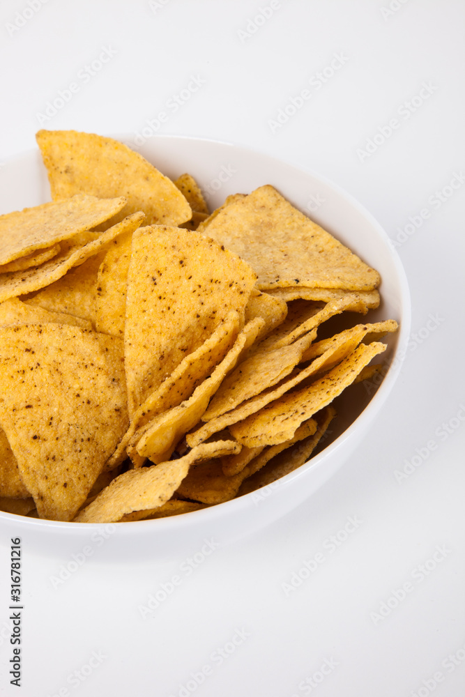 Close-up of nachos in bowl over white background