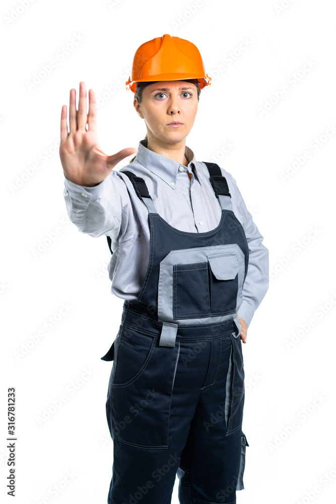 girl in orange helmet shows hand stop sign. Isolated girl in orange helmet shows hand stop sign. Isolated