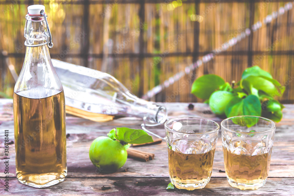 apple juice poured into glasses, on a wooden background, in warm colors apple juice poured into glasses, on a wooden background, in warm colors