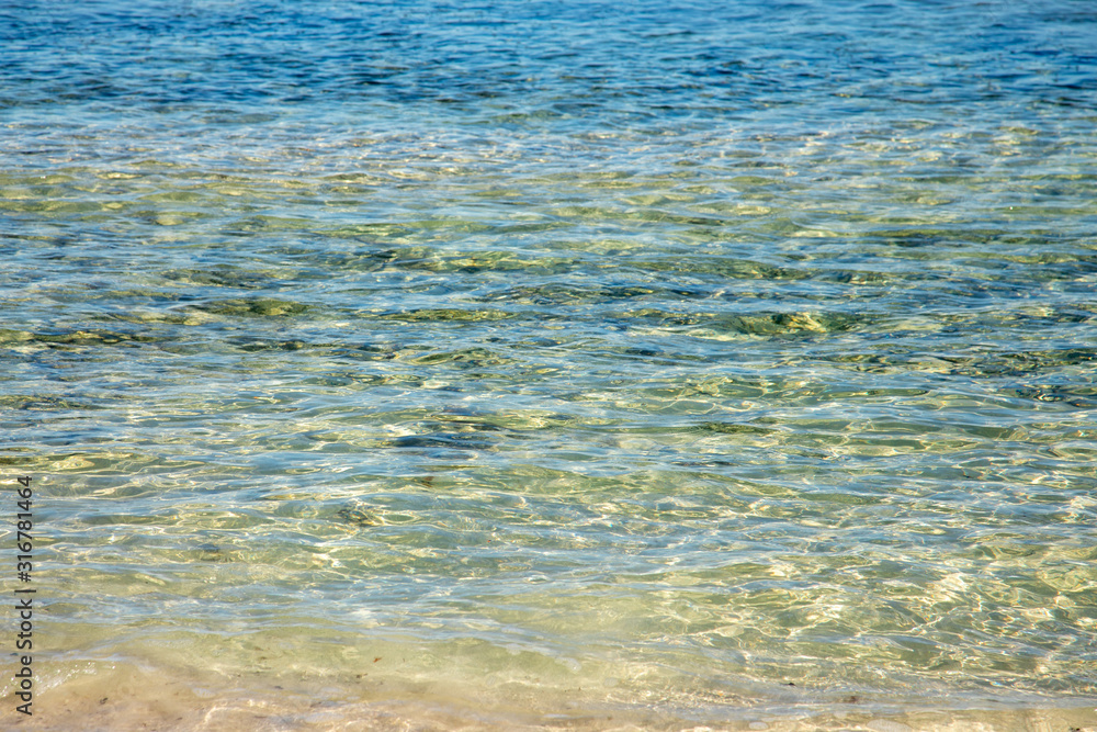 Beach sea water surface in diferente colors azure aquamarine blue turquoise calm scene background