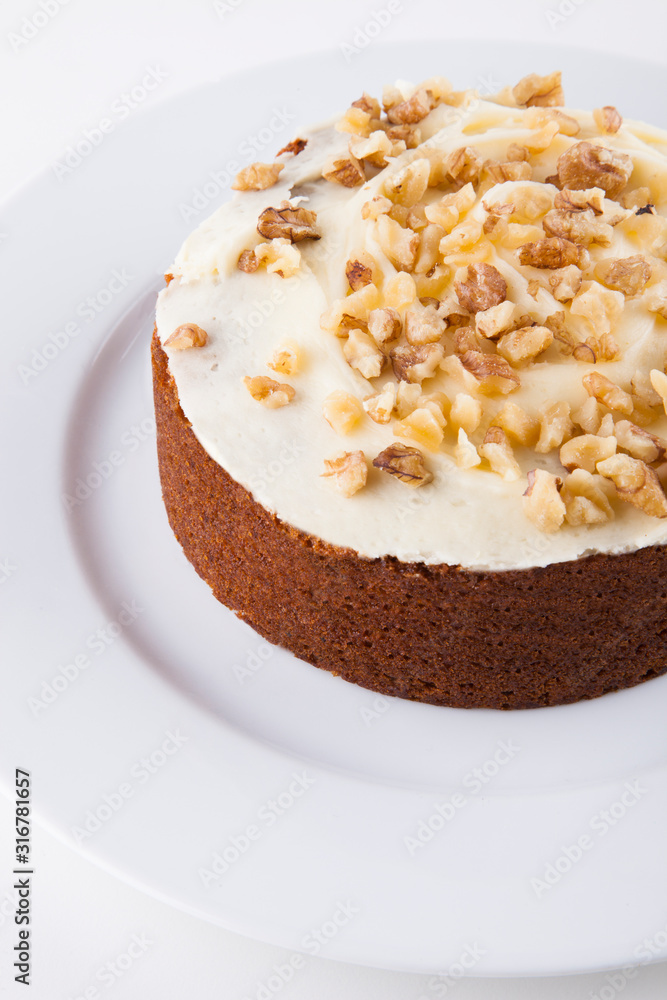 Walnut cake in plate over white background