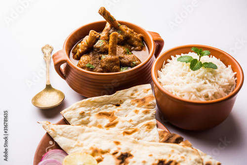 Hyderabadi Mutton Paya, Nehari, nazari or Nihari Masala. served with Naan and rice. selective focus photo