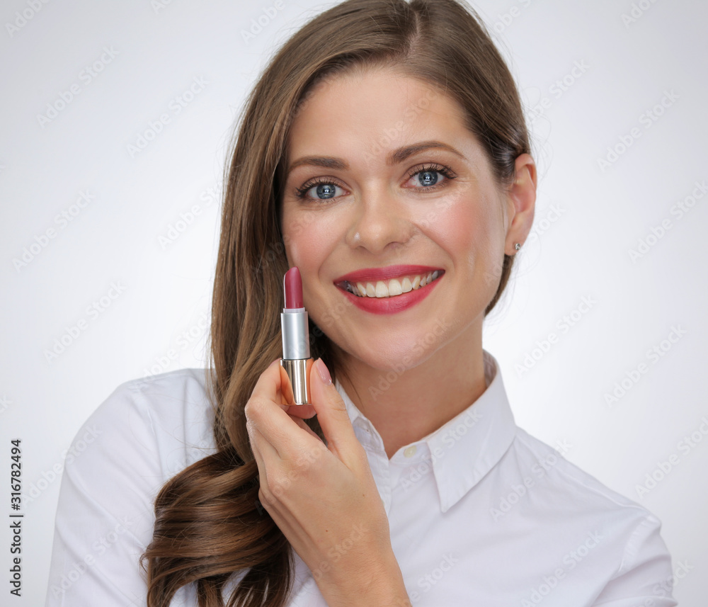 toothy smiling half face portrait of woman holding lipstick. toothy smiling half face portrait of woman holding lipstick.