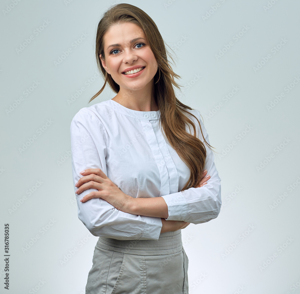 Smiling woman in white shirt posing with crossed arms. Smiling woman in white shirt posing with crossed arms.