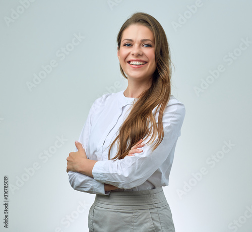 Smiling woman with toothy smile wearing white shirt.