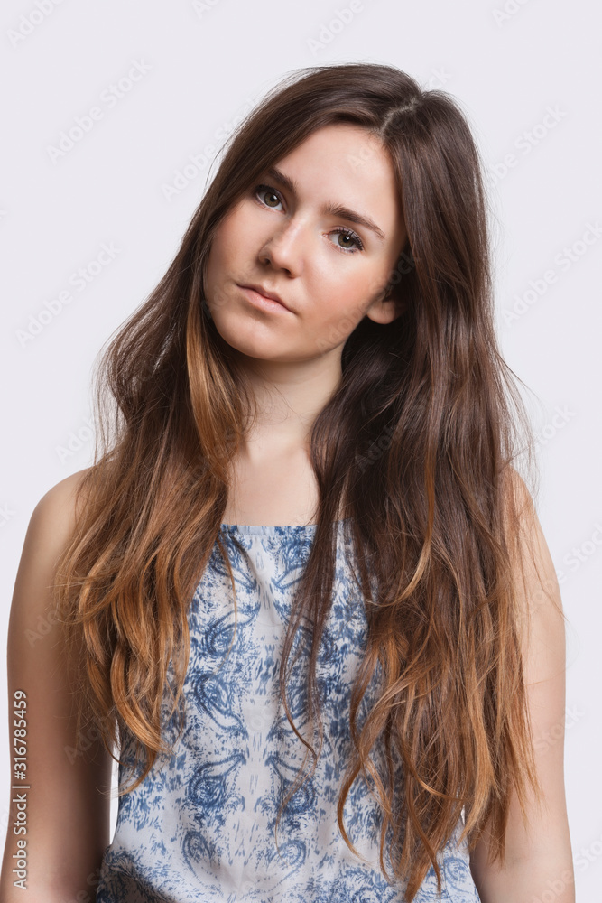 Portrait of serious young woman over white background Portrait of serious young woman over white background