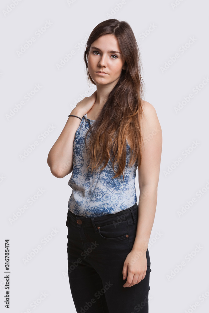 Portrait of serious young woman over white background Portrait of serious young woman over white background