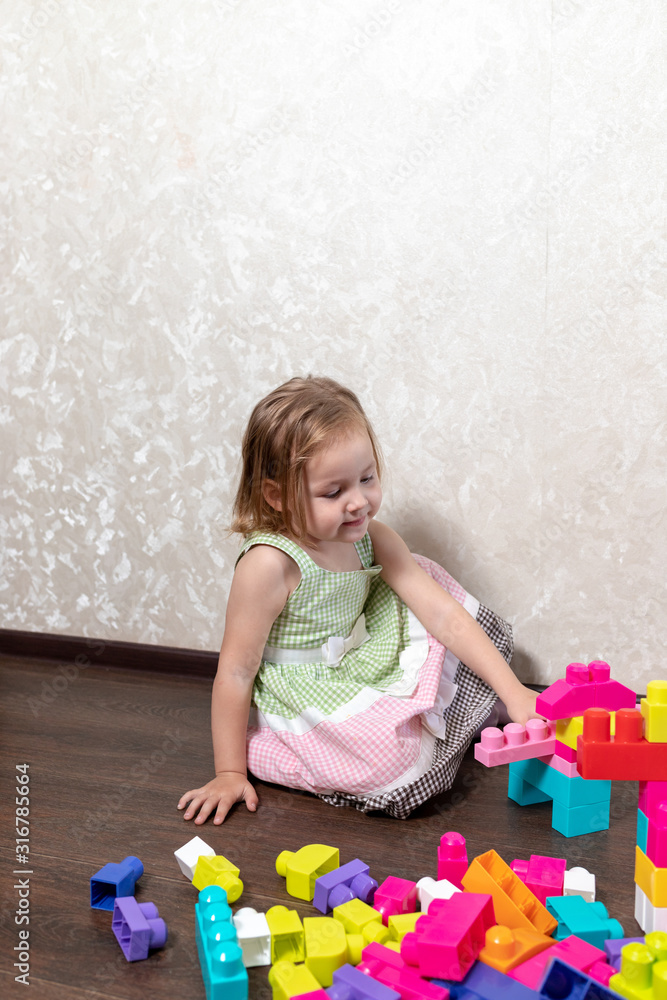 The child plays in the constructor. the child builds from the designer figures of animals and robots The child plays in the constructor. the child builds from the designer figures of animals and robots