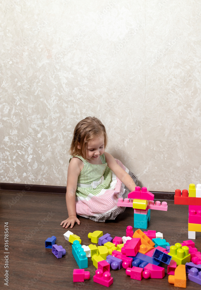 The child plays in the constructor. the child builds from the designer figures of animals and robots The child plays in the constructor. the child builds from the designer figures of animals and robots