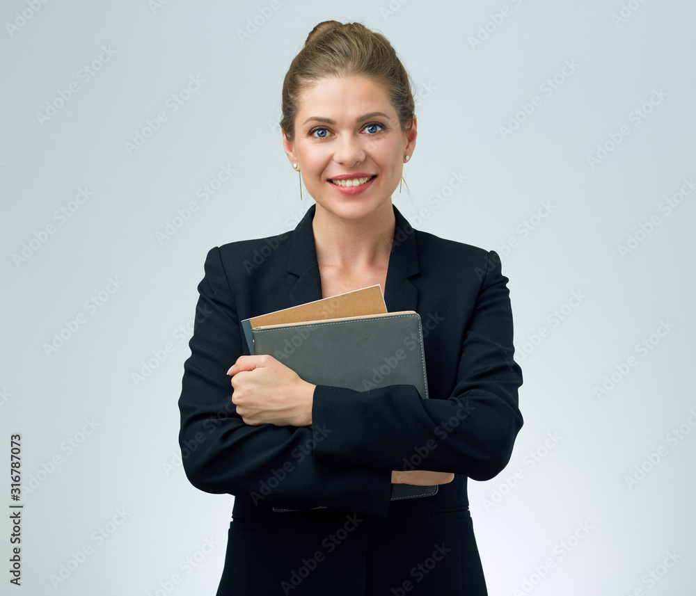 Smiling woman teacher in black suit holding books. Smiling woman teacher in black suit holding books.