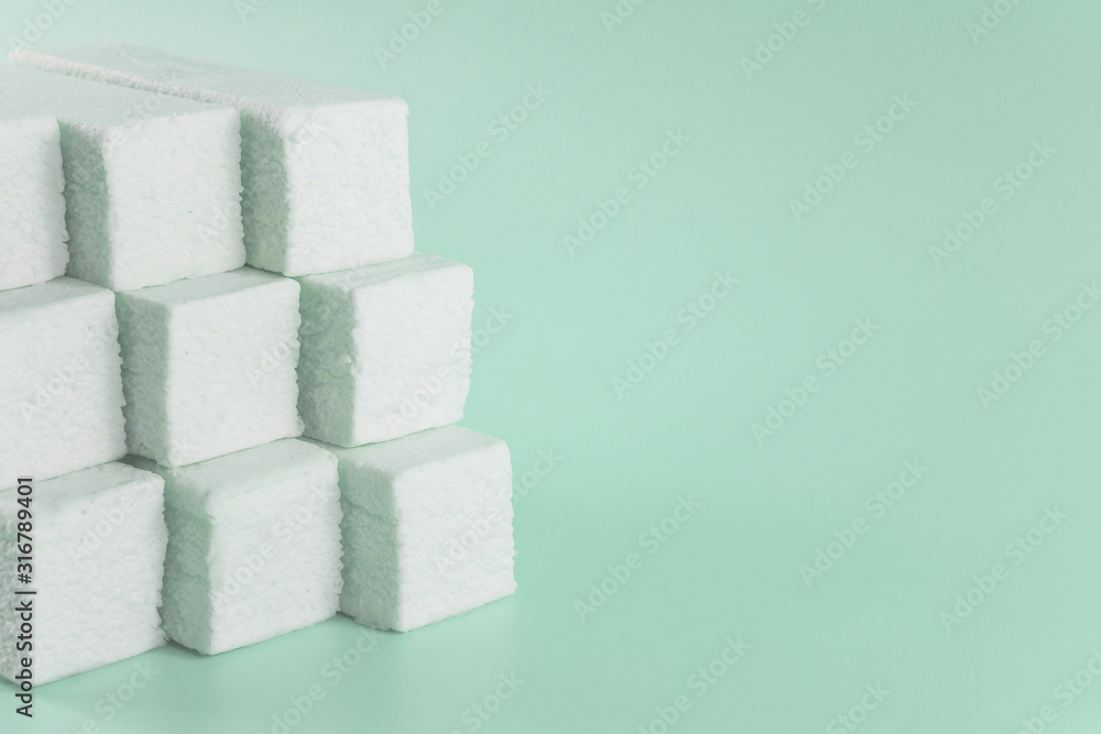 Sweet green marshmallow with mint flavor in the form of a geometric shape Sweet green marshmallow with mint flavor in the form of a geometric shape