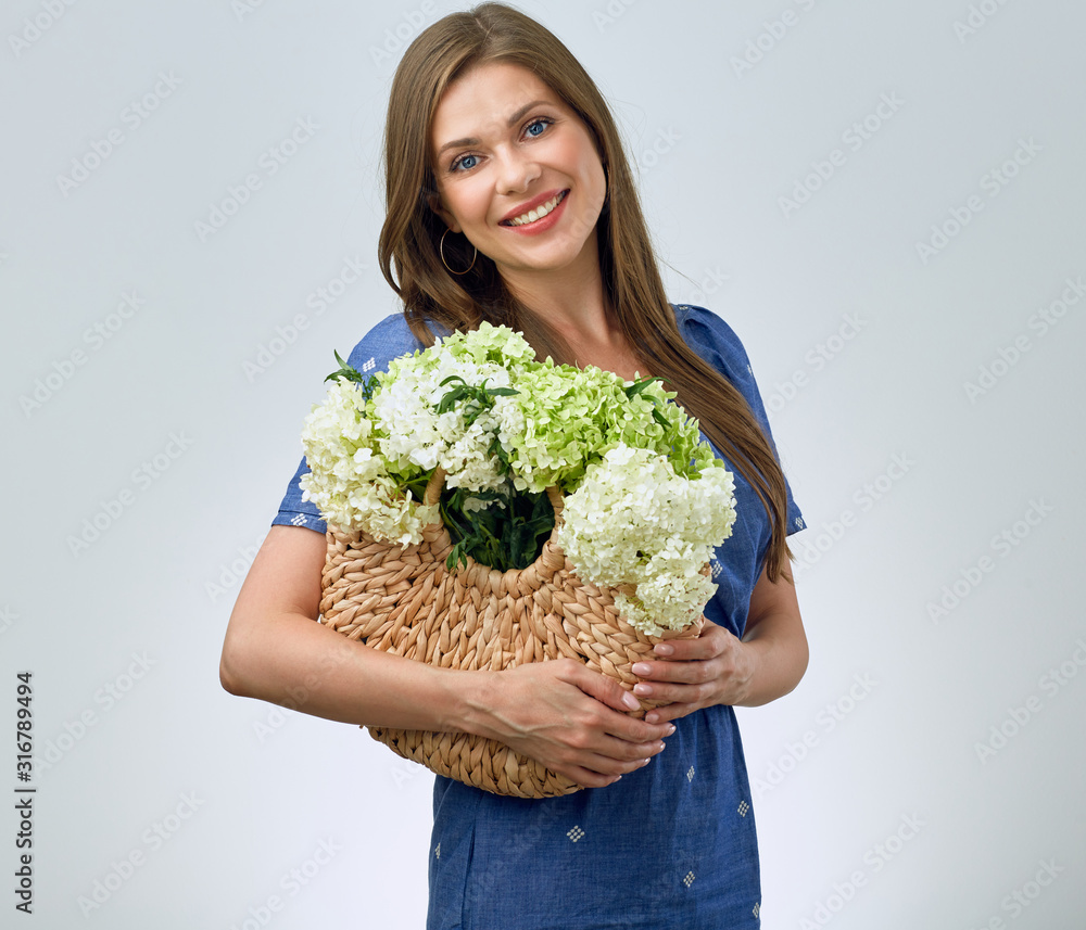 Smiling woman in blue casual dress with white green flowers. Smiling woman in blue casual dress with white green flowers.