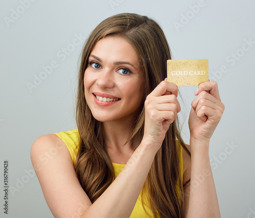 close up face portrait of smiling happy woman holding credit card. photo