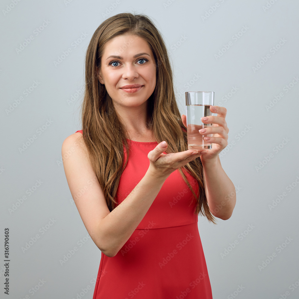 Smiling woman in red dress holding water glass. Smiling woman in red dress holding water glass.