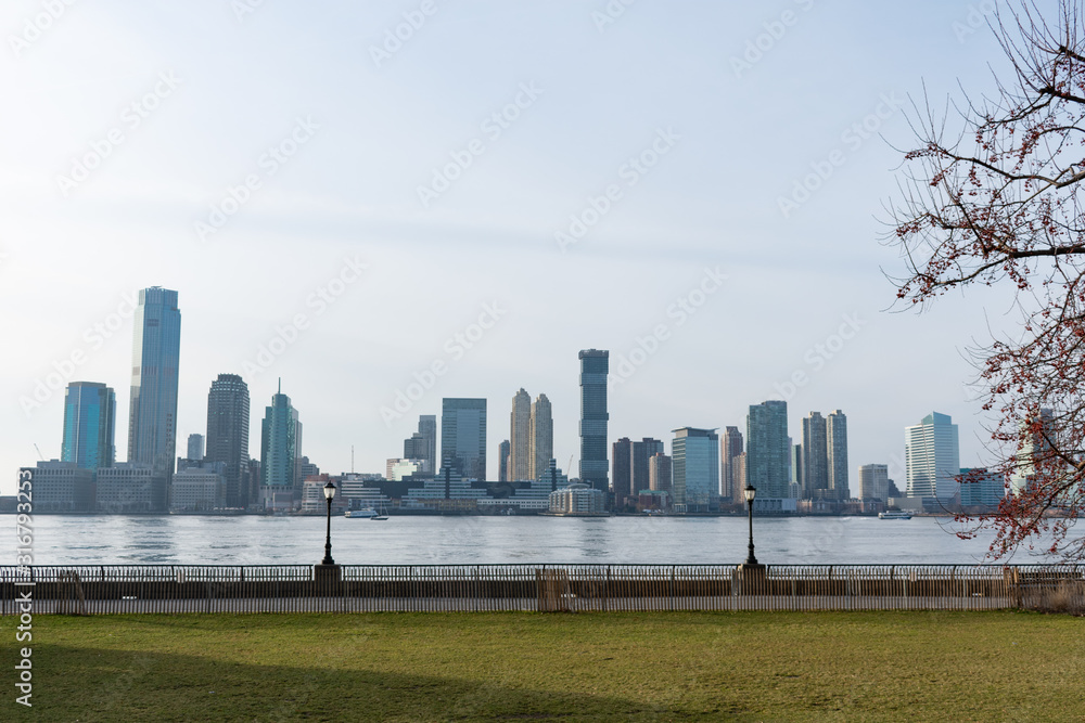 Empty Waterfront at Battery Park in New York City with a view of the Jersey City Skyline along the Hudson River