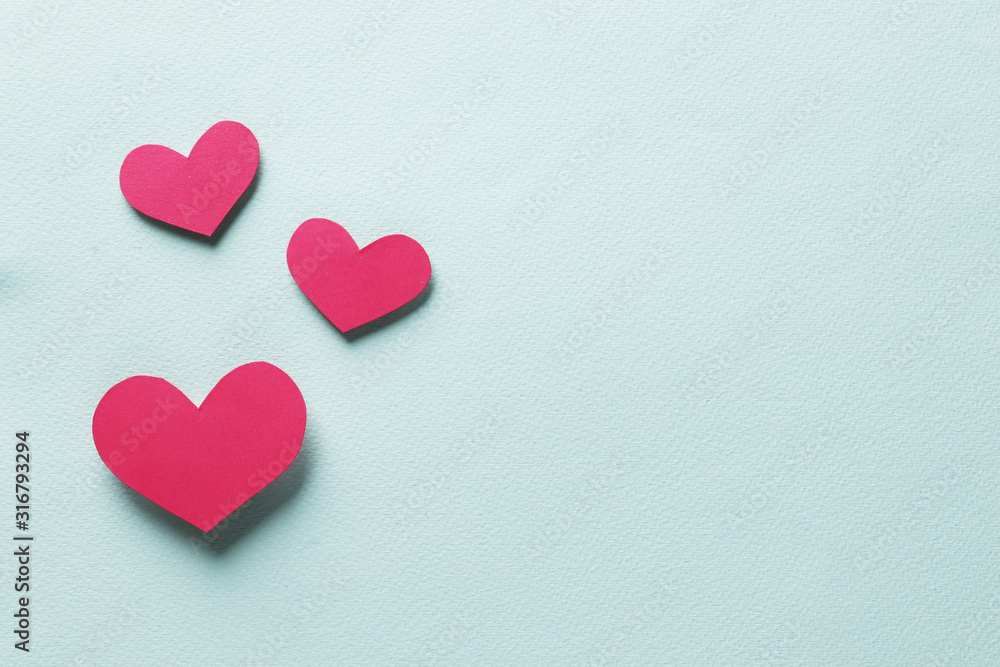 Decorative hearts on a blue background. Valentine's day decor concept. February 14