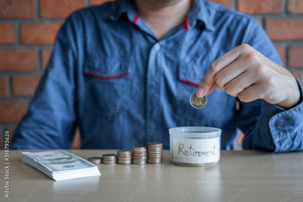 Man putting coins into money box with savings and analysis business investment strategy with income of money coin and dollar for future travel, retirement financial concept Man putting coins into money box with savings and analysis business investment strategy with income of money coin and dollar for future travel, retirement financial concept