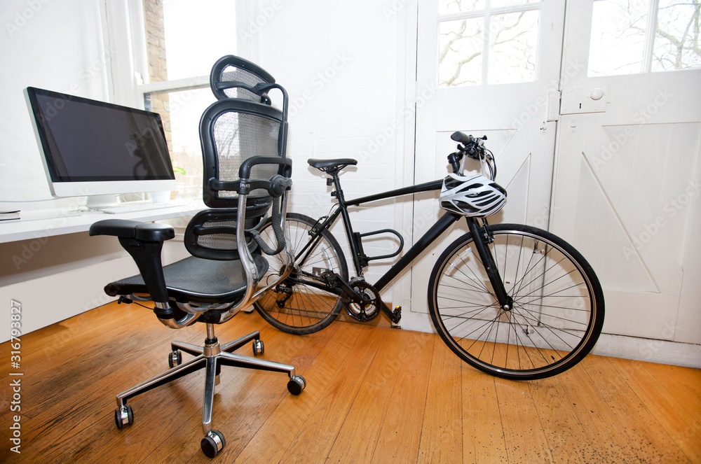 PC, Desk and Bicycle inside an office PC, Desk and Bicycle inside an office