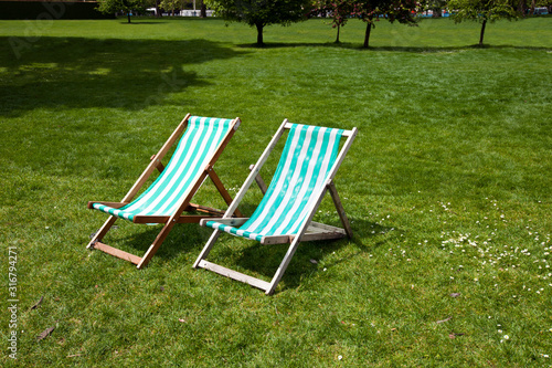 Two deck chairs in a park