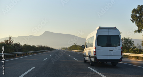 sightseeing minibus performing transfer tourists to natural parkland photo