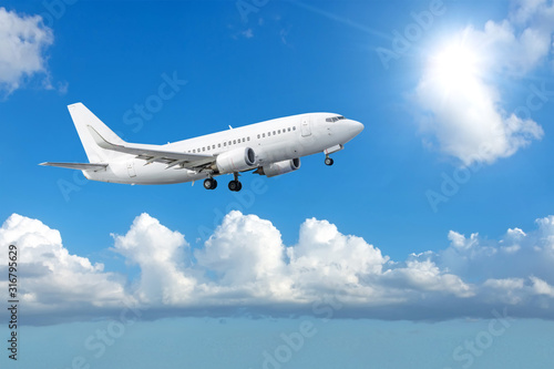 Passengers commercial airplane flying among the clouds sunshine. Concept travel by air.