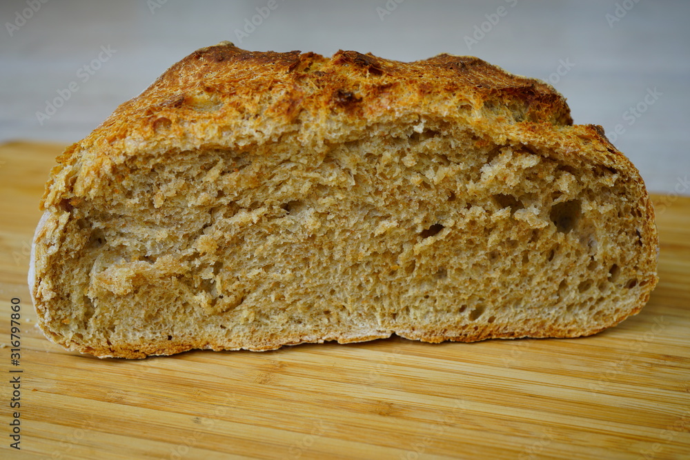 Loaf of crusty miracle overnight no knead bread cut in half Loaf of crusty miracle overnight no knead bread cut in half