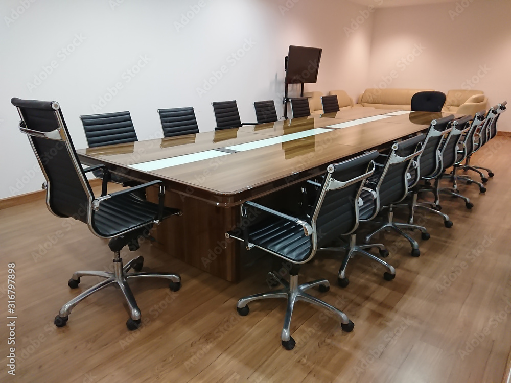 Small meeting room with Black leather seats.Meeting room professional board room with chairs and table in office Small meeting room with Black leather seats.Meeting room professional board room with chairs and table in office
