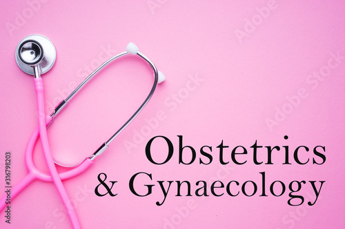 Women in healthcare concept. A pink strethoscope on a pink background with Obstetrics and Gynaecology text.