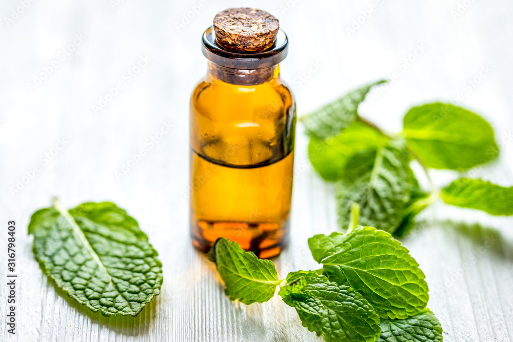 organic cosmetics with herbal extracts of mint on wooden background organic cosmetics with herbal extracts of mint on wooden background
