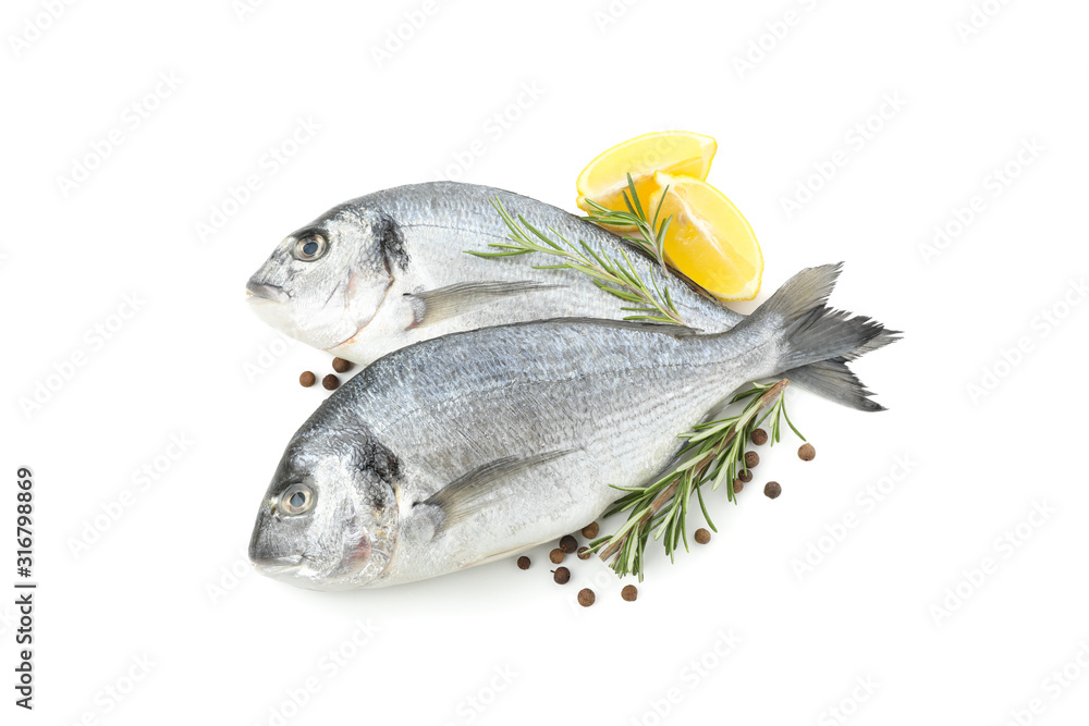 Dorado fishes, lemon, rosemary and pepper isolated on white background Dorado fishes, lemon, rosemary and pepper isolated on white background