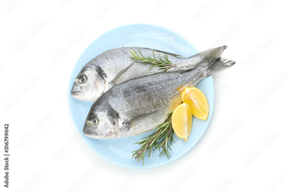 Plate with Dorado fishes, lemon and rosemary isolated on white background Plate with Dorado fishes, lemon and rosemary isolated on white background