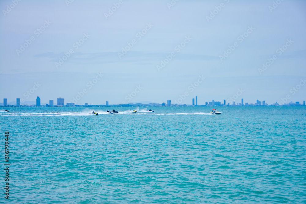 group of tourists sailing on jet skis off the coast Near Pattaya in Thailand,group of jet ski park at the beach on the morning at Larn island,Chonburi,Thailand