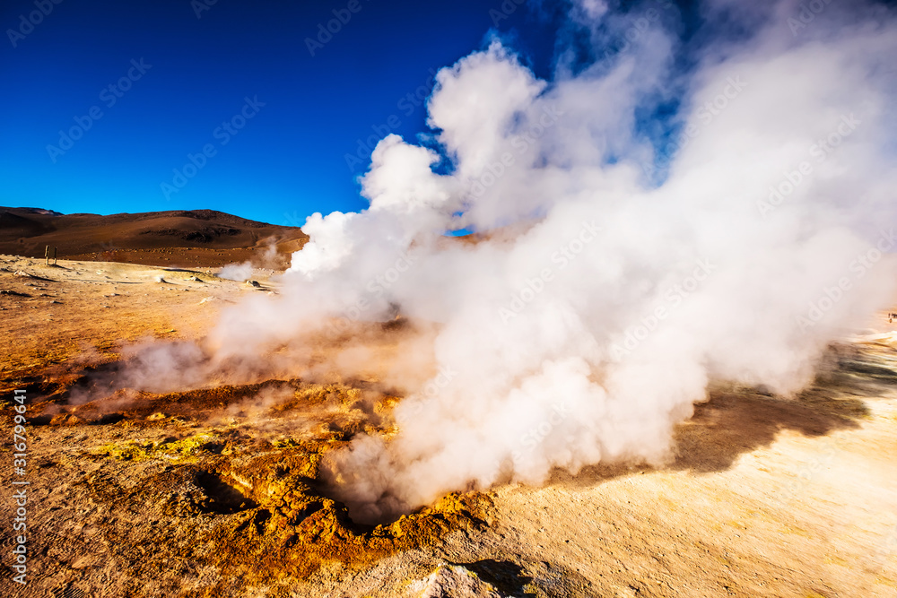 Sunshine Boivian desert landscape with huge steaming geysers