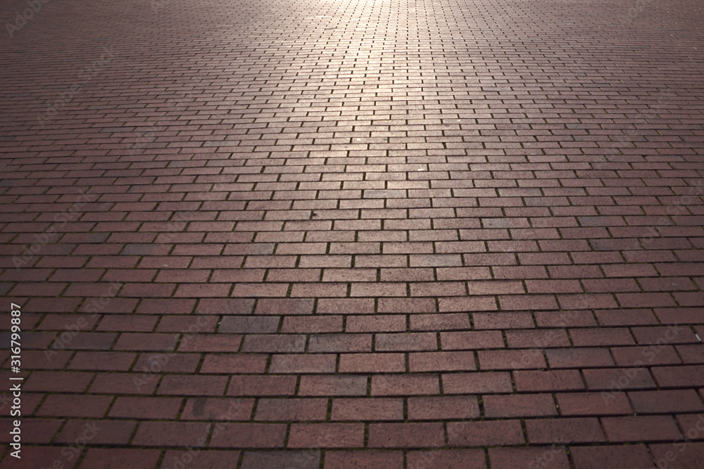 texture of red paving slabs for background in perspective, lit by the sun texture of red paving slabs for background in perspective, lit by the sun