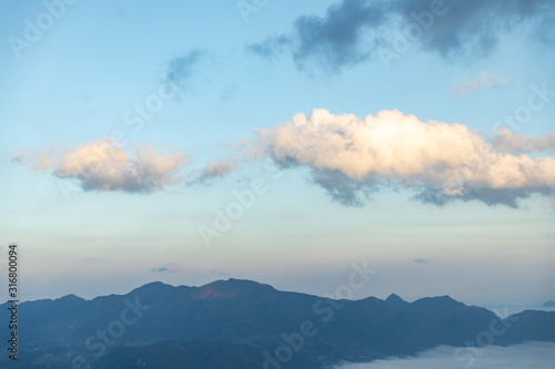 landscape view of mountain range under mist with sky cloud