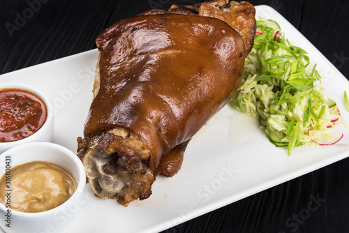 Tasty pork knuckle with sau...